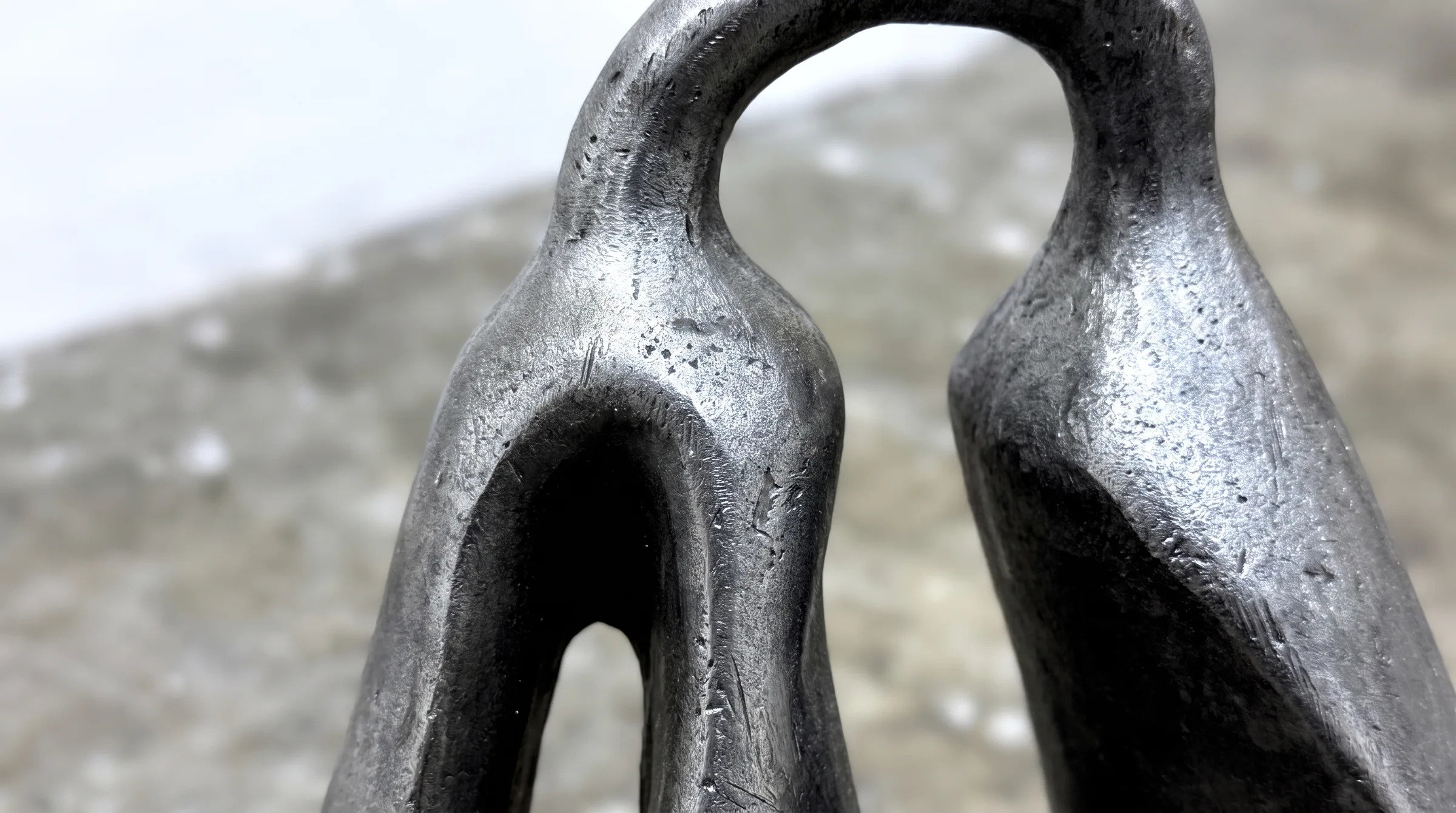 Close crop of the two handles, the cast surface catching the light
