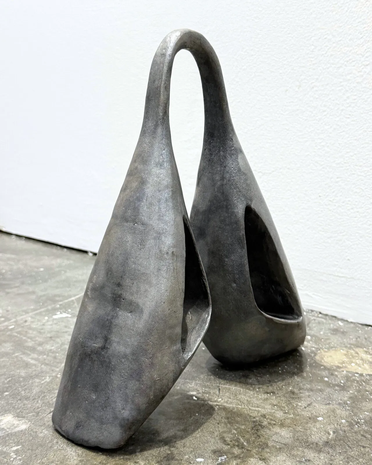 Ogene MIDI: 002 in cast aluminium, the two forms leaning together, one mouth open to the camera