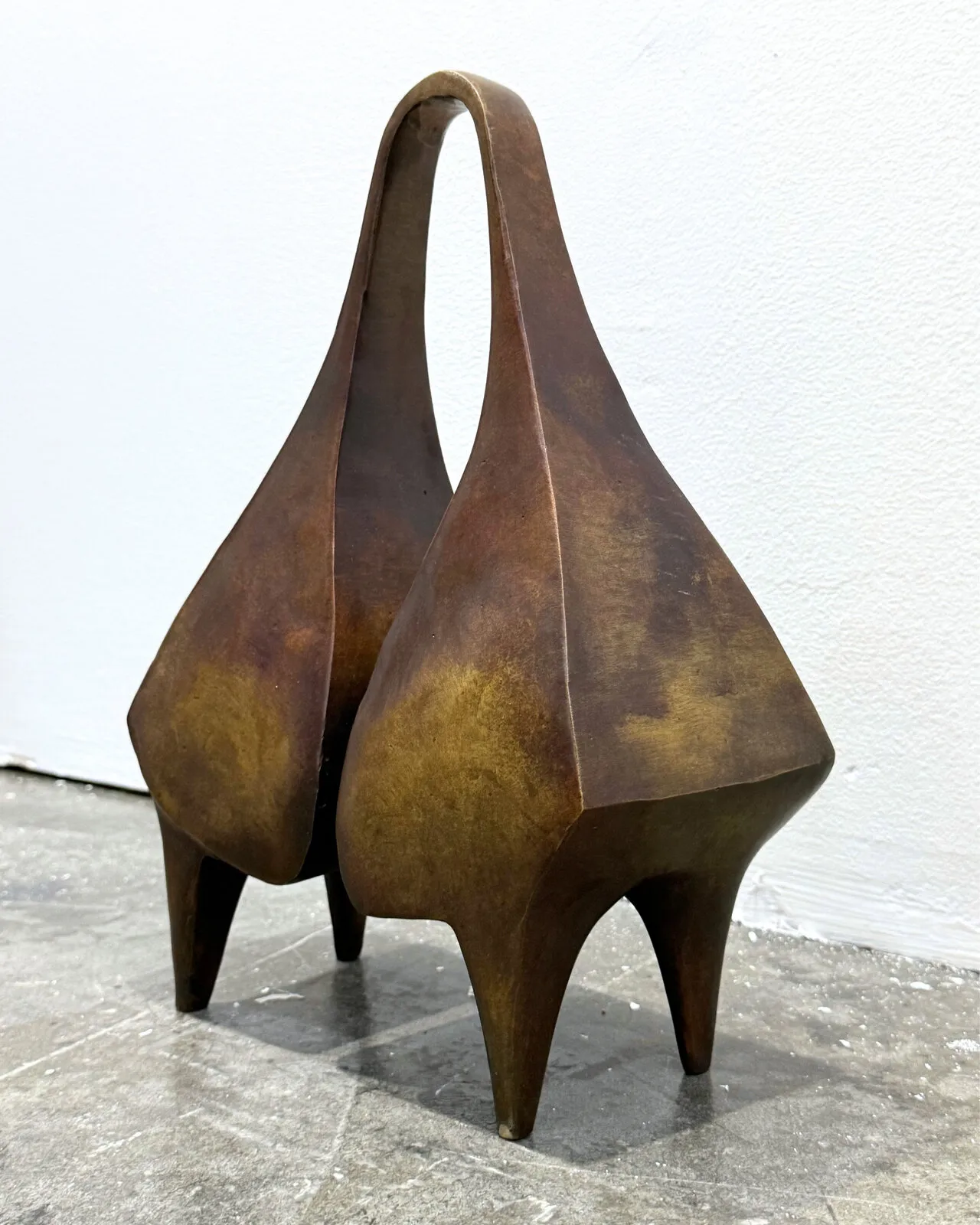 Three-quarter view of the sculpture, the bells turned away from the camera