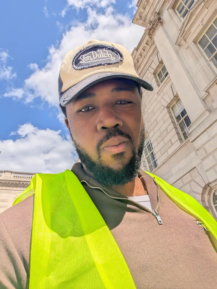 Chidirim Nwaubani in a hi-vis vest outside Somerset House on install day